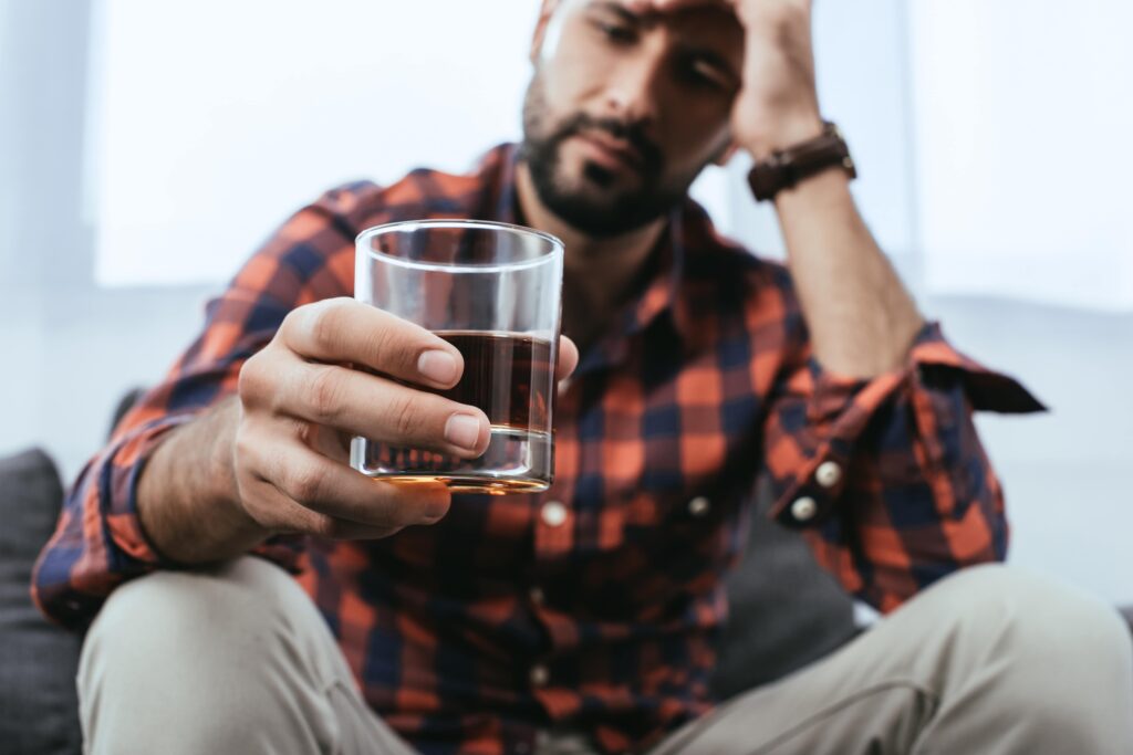 A man with yellow eyes from drinking.