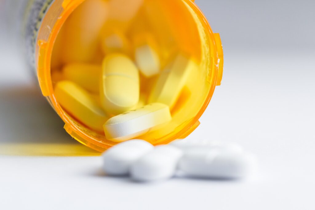 bottle of gabapentin pills knocked over and a table