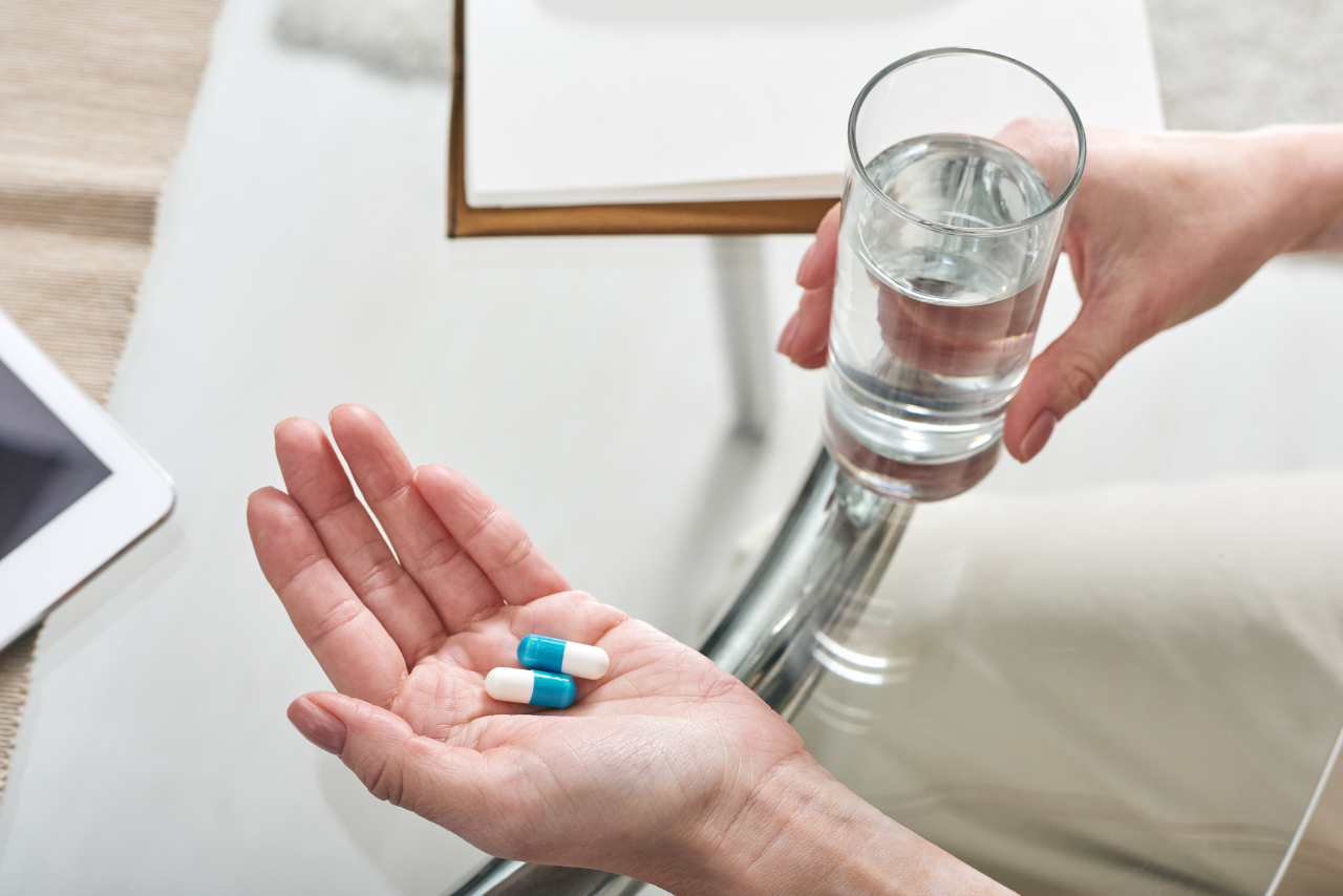 man holding out his medication wondering how long does adderall stay in your system