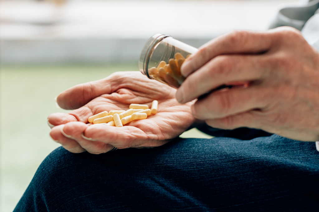 woman holding out a hand pouring pills in it wondering can you get addicted to adderall