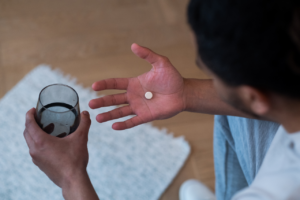 man getting ready to take his medication afraid of getting adderall tongue